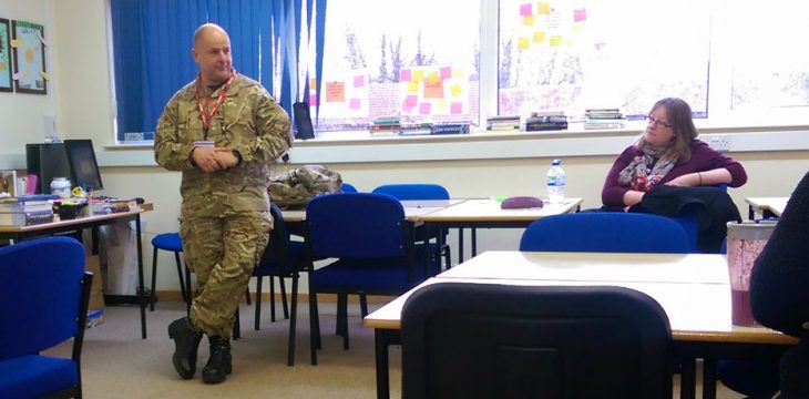 Serving Army Officer Works With Students Studying Impact Of War
